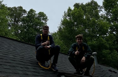 two men sitting on a roof top