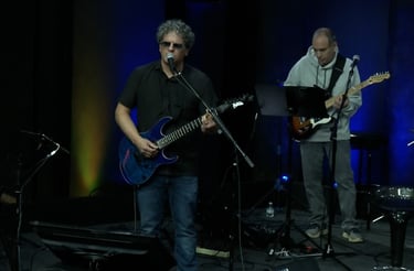 a band of musicians playing instruments on stage