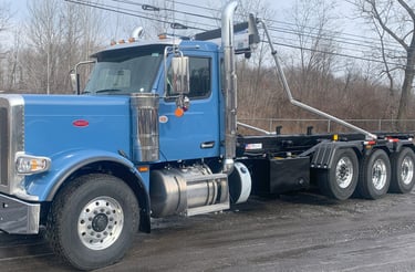 blue Peterbilt roll-off truck