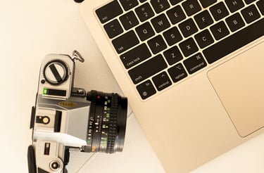 a camera and a labtop on a table