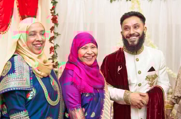 candid photo of groom with his mum and aunty, all laughing and smiling 