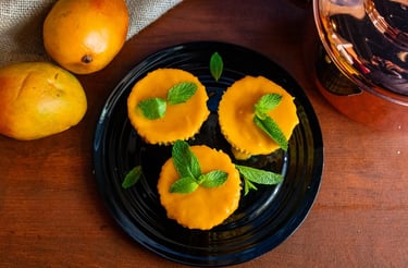 Mango lassi cheescake varnished with a mint leaf on top- plated