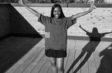 a woman standing on a deck with her arms up