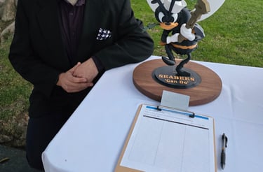 Our founder, next to a donated statue up for auction, with proceeds going to the annual Seabee Ball