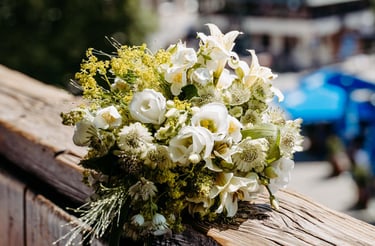 a bouquet of flowers on a wooden fence