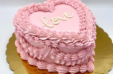 a pink heart shaped cake with a heart shaped cake