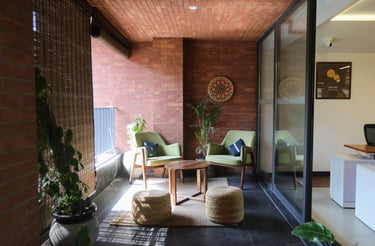 a living room with a couch and a chair- 371 workspace clayworks