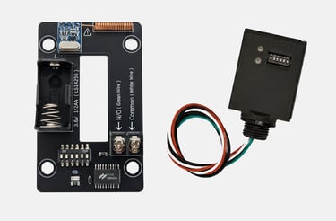Electronic circuit board and wireless transmitter kit with a battery holder and color-coded wires.