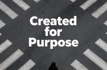 A motivational sign with various inspirational phrases such as 'LIVE FULLY', 'CREATE HAPPINESS', and 'LOVE DEEPLY' is placed next to a window with raindrops visible on the glass. The setting is dimly lit, creating a cozy and reflective atmosphere.