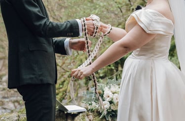 a man and woman holding hands and a rosary