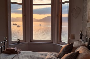 The bed at Gourock Seaview Holiday Let with the bed and a view of the sea