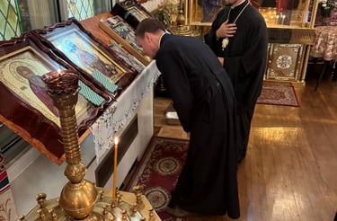 a priest is kneeling down to a priest