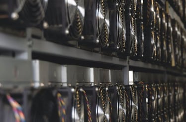 A row of cooling fans on ASIC crypto miners in a professional bitcoin mining farm.