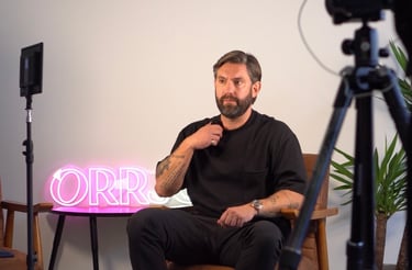 a man sitting in a chair with a camera and a camera