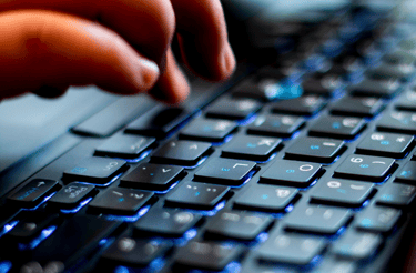 Fingers hovering above a keyboard