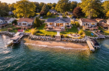 Drone view of a lakefront cottage along the shoreline