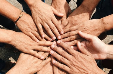 A friendly corporate meeting with people shaking hands in a bright office.