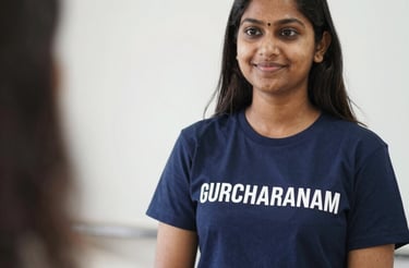 A friendly student and teacher chatting over a laptop in a bright, modern study space.