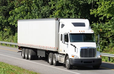 A friendly dispatcher speaking on a headset with trucks moving in the background.