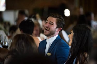 male wedding guest laughing