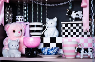 Pastel goth shelf with a bunch of different colored mugs