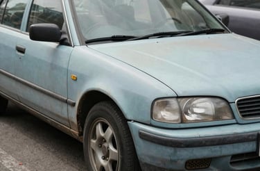 Modern dark-themed luxury car showroom with a glossy black vehicle under soft lighting.