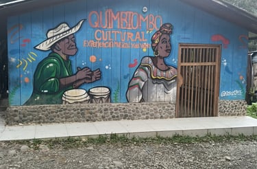 Mural of Afro-Colombian musicians on a blue wooden building for Quimbiombo Cultural heritage.