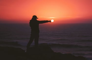 Abundance at the Ocean. A silhouette reaches out over the ocean during a glorious sunset.