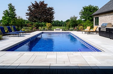Luxury porcelain paver pool deck installation at a Sarasota home with modern limestone-style design