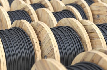 a bunch of wooden cable reels are lined up