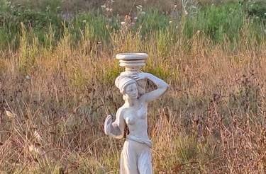 a statue of a woman with a bowl on her head