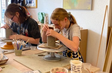 a woman is making a clay pottery pottery pottery pottery pottery pottery pottery pottery pottery pottery