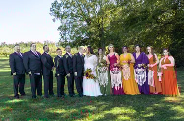 a group of people standing in front of a tree