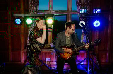 a man and woman playing guitar together