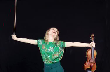 Houston violin teacher holding her violin
