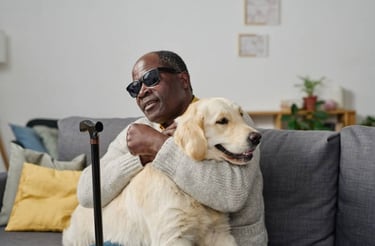 Man on couch hugging dog