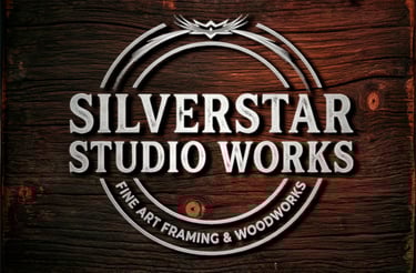 Silverstar Studio Works logo for fine art framing and woodworks on a dark rustic wood grain background.