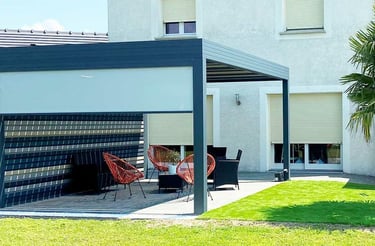 a patio with a table and chairs in the grass