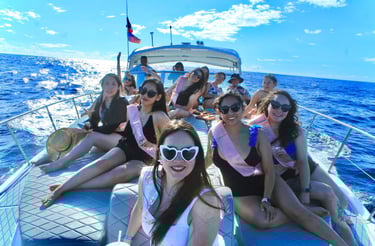 A group of women celebrating a bachelorette party on a private boat tour at sea.