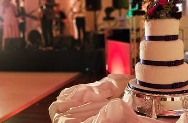 a wedding cake with a band playing on the stage