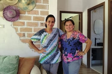 two women standing next to each other in a living room