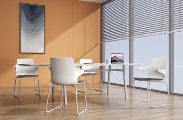 Modern meeting room with white sled-base chairs around a rectangular table, set against an orange wa