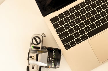 a camera and a labtop on a table