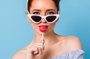 a woman with sunglasses and lollipops on a blue background