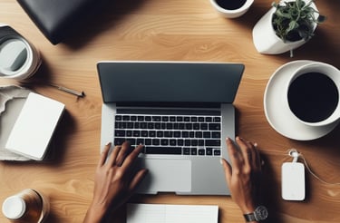 A person sitting at a desk with a laptop and a coffee cup.