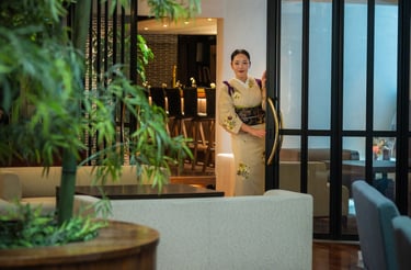 a woman dressed in kimono greeting customers in the lobby of the japanese hotel Chaharu in Matsuyama