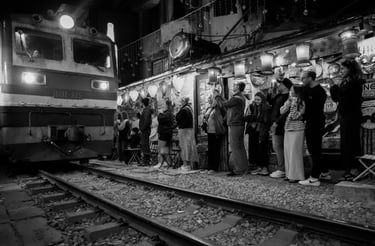 Hanoi Train Street black and white night photography train passing narrow street