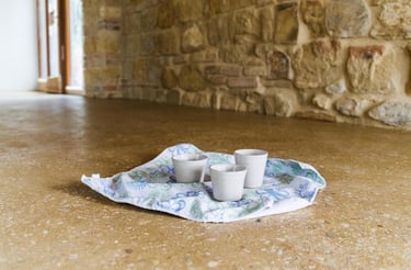 espresso cups resting on the shiny polished rammed earth floor