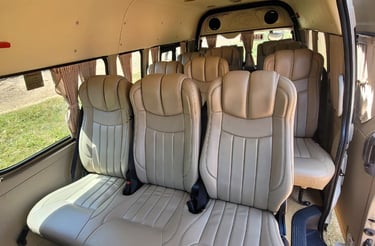 Luxury & spacious passenger van interior with beige reclining leather seats 