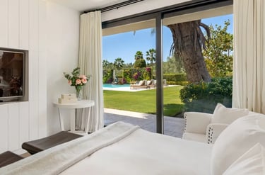 Guest suite with garden views and modern interior design at Villa El Olivo, Marbella